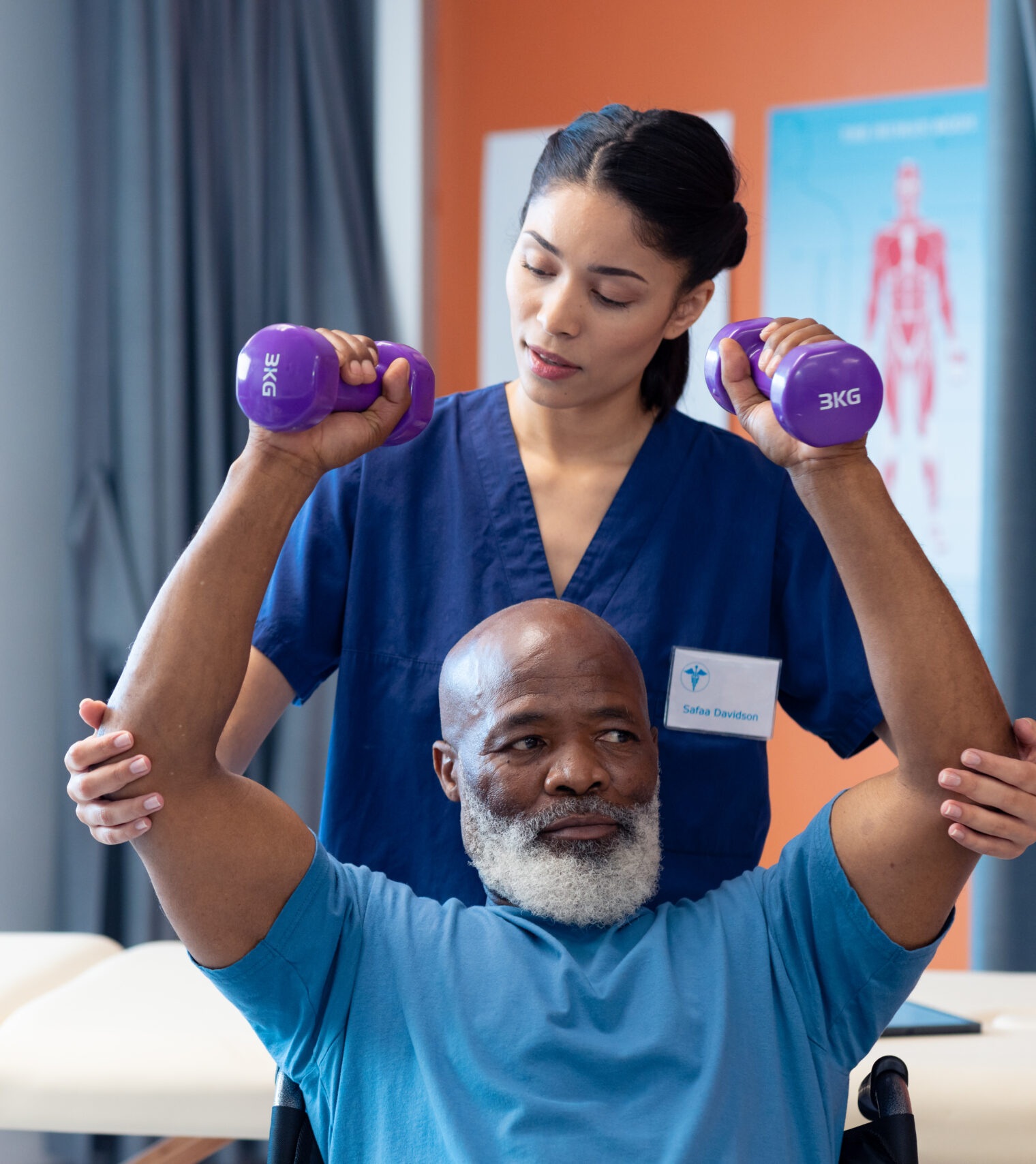 diverse female physiotherapist helping senior male patient exercise with dumbbells, copy space. hospital, medical and healthcare services.